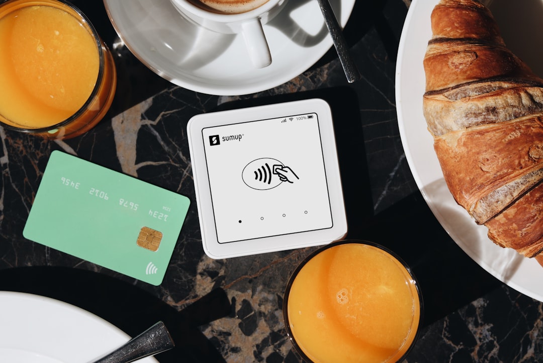 A SumUp card reader is placed on a table, ready to accept contactless payments. The setup is ideal for small businesses and cafés, offering a sleek and efficient way for entrepreneurs to accept payments.